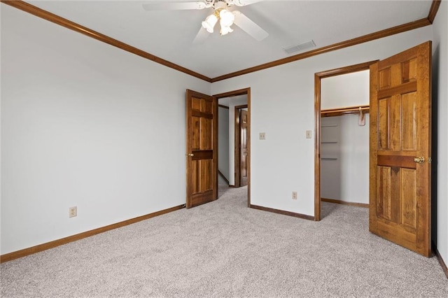 unfurnished bedroom with light carpet, a closet, ceiling fan, and crown molding