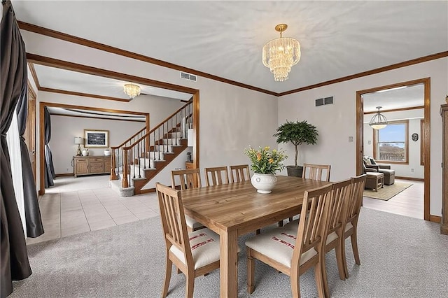 dining space featuring stairway, visible vents, an inviting chandelier, and light colored carpet