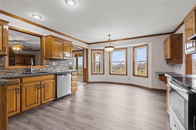 kitchen with electric range oven, wood finished floors, a sink, brown cabinets, and dishwasher