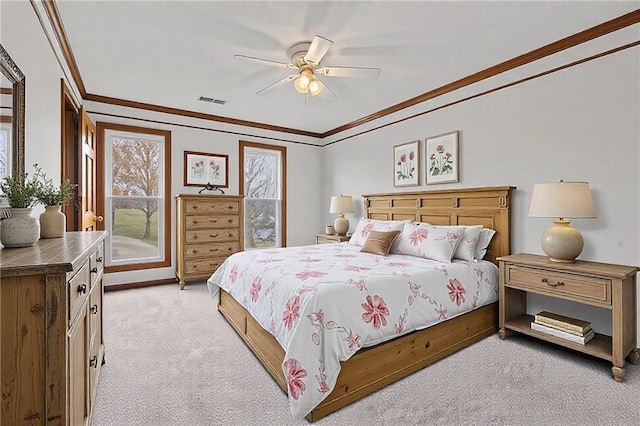 bedroom with ornamental molding, visible vents, light carpet, and a ceiling fan