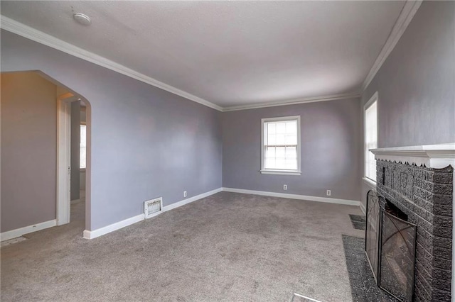 unfurnished living room featuring carpet, crown molding, and a brick fireplace