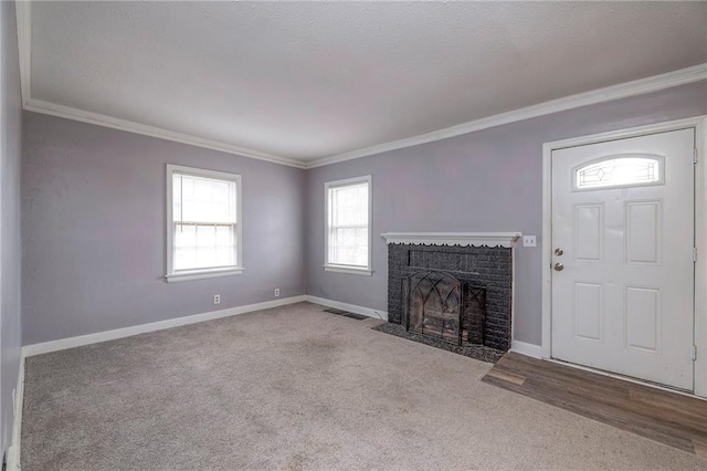 unfurnished living room with crown molding, light colored carpet, and a fireplace