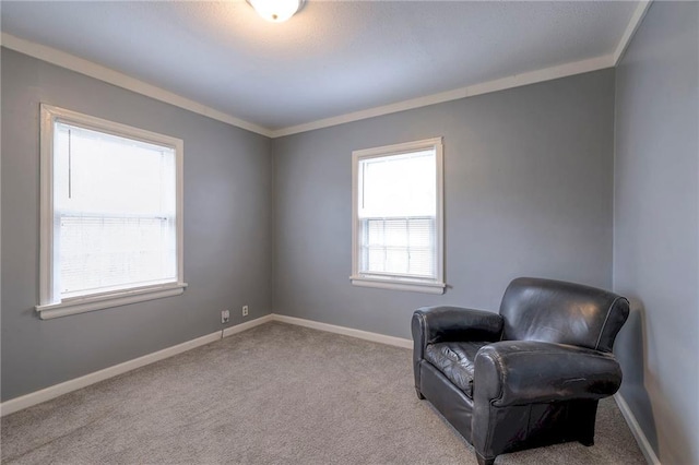 sitting room featuring crown molding and a healthy amount of sunlight