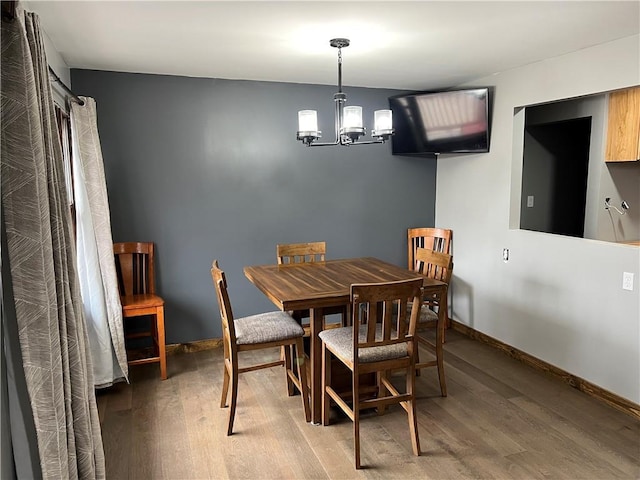 dining room featuring hardwood / wood-style flooring and a notable chandelier