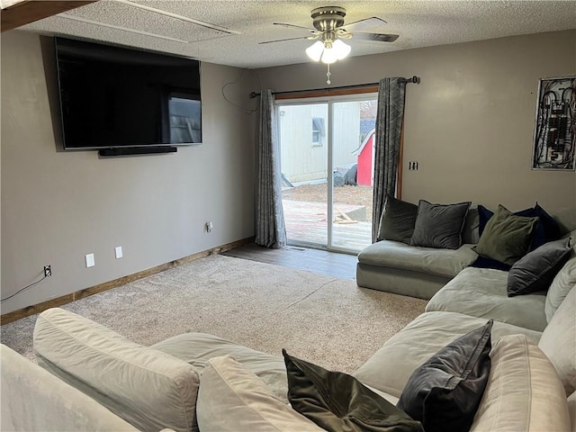 carpeted living room featuring a textured ceiling and ceiling fan