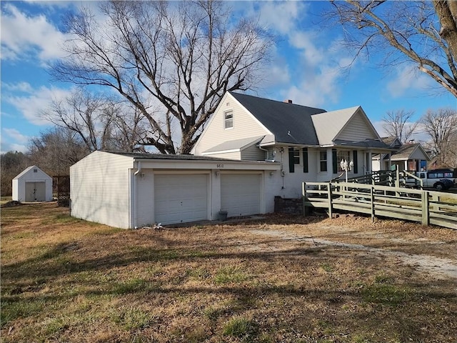 exterior space featuring a garage and a lawn