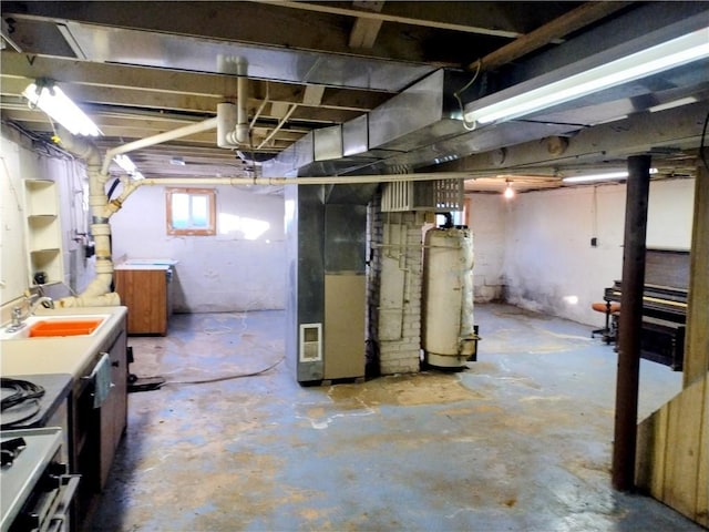 basement featuring sink and heating unit