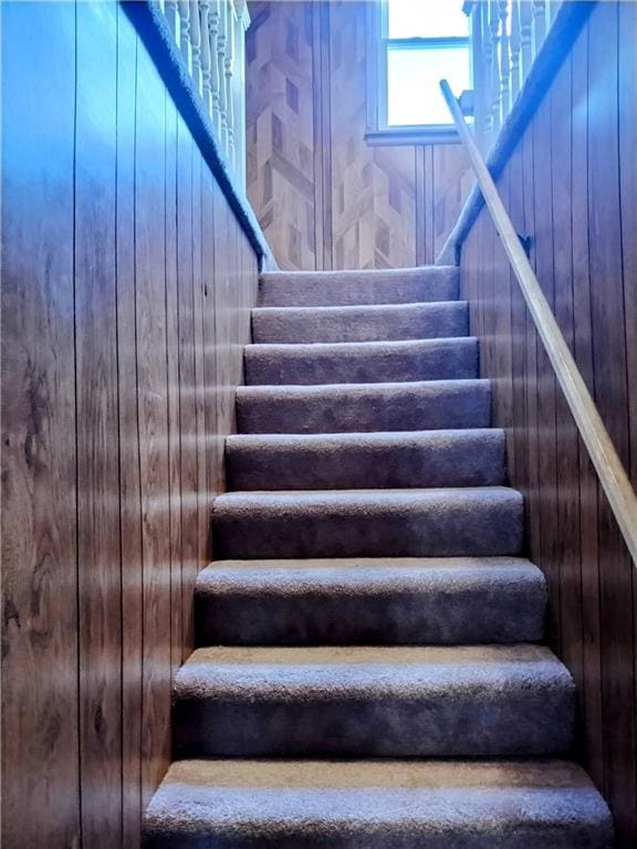 staircase with wooden walls