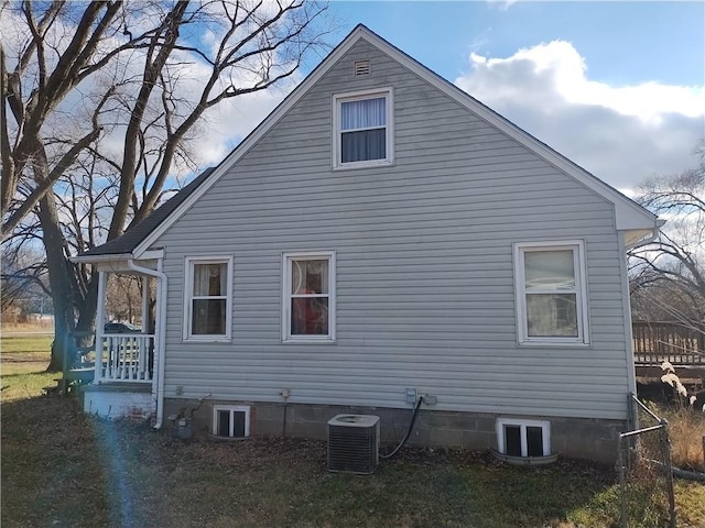 view of side of home with central AC unit