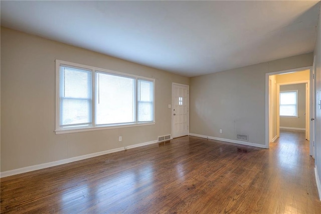 unfurnished room featuring dark hardwood / wood-style flooring