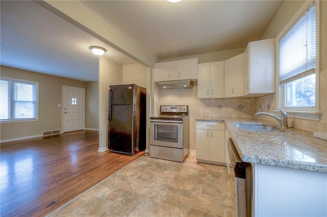 kitchen with white cabinets, appliances with stainless steel finishes, a wealth of natural light, and sink