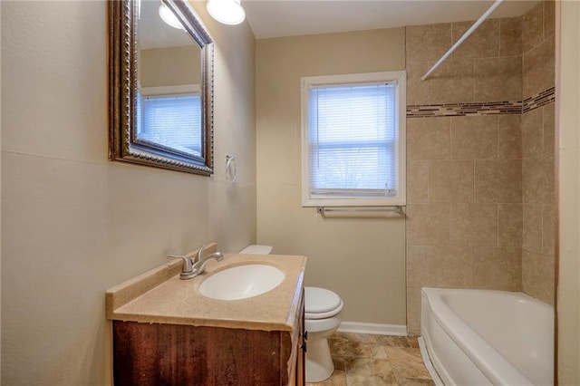 full bathroom with vanity, toilet, and tiled shower / bath combo