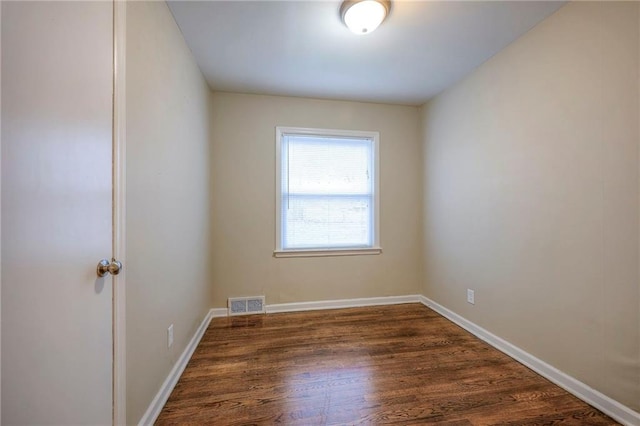 empty room featuring dark hardwood / wood-style floors