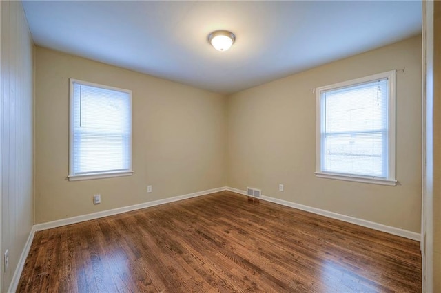 unfurnished room featuring dark hardwood / wood-style flooring