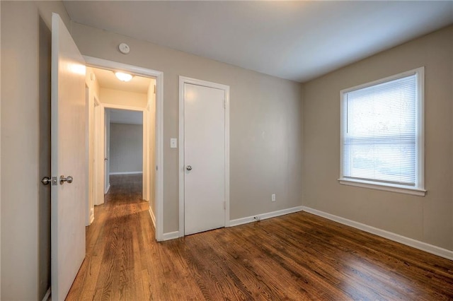 unfurnished room with hardwood / wood-style flooring