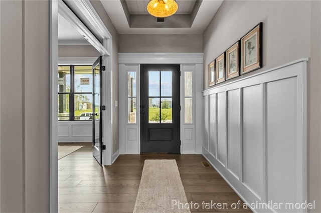 13450 W 179th Ter, Overland Park, KS 66013 - entrance foyer with a tray ceiling, a decorative wall, visible vents, and wood finished floors