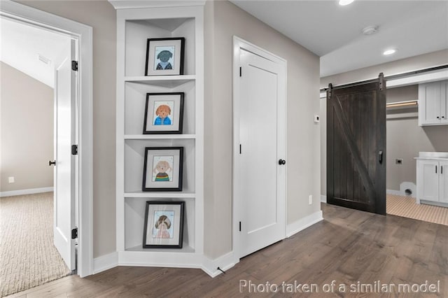 13450 W 179th Ter, Overland Park, KS 66013 - hallway featuring recessed lighting, a barn door, baseboards, and dark wood-style floors