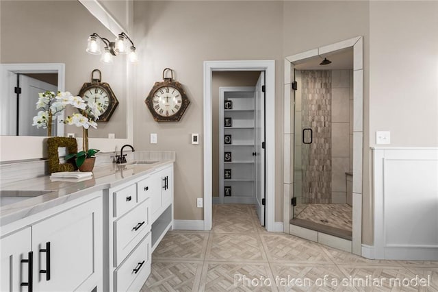 13450 W 179th Ter, Overland Park, KS 66013 - full bathroom featuring a sink, double vanity, a stall shower, and baseboards