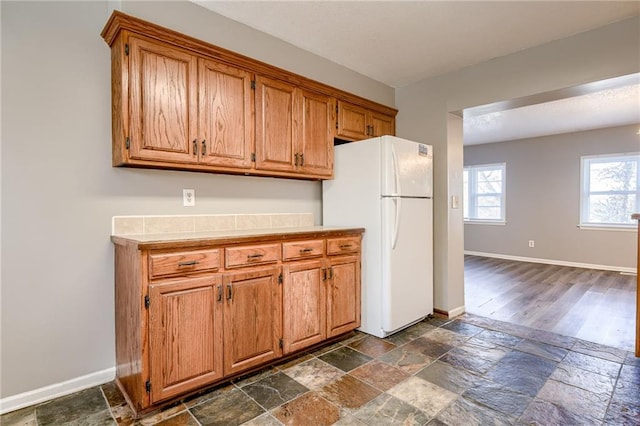 kitchen with white fridge and dark hardwood / wood-style floors