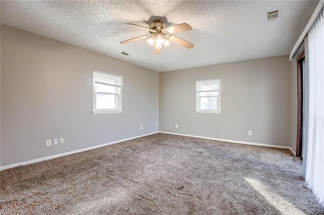 empty room with a textured ceiling and a healthy amount of sunlight