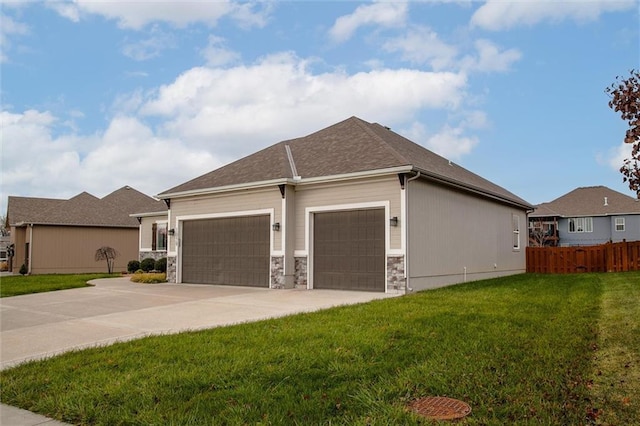 view of front of house featuring a garage, stone siding, a front lawn, and concrete driveway