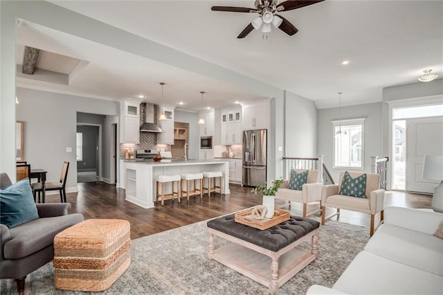 living area featuring baseboards, ornamental molding, dark wood-style flooring, and recessed lighting