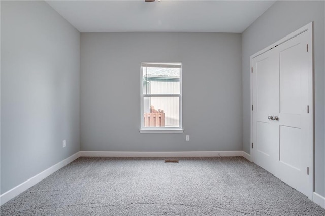 unfurnished bedroom featuring visible vents, baseboards, and carpet floors