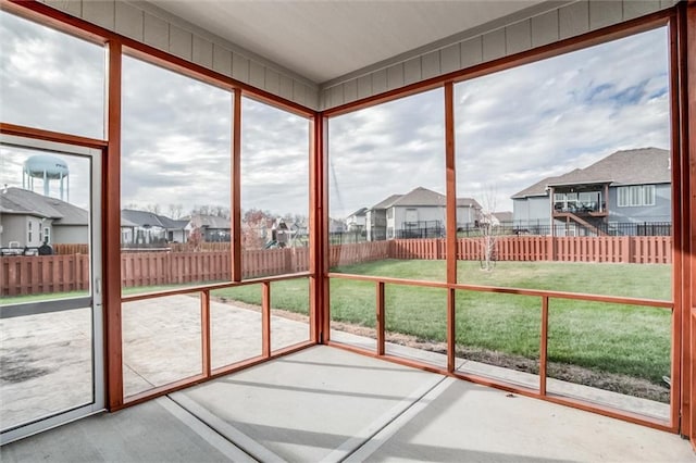 unfurnished sunroom with a residential view