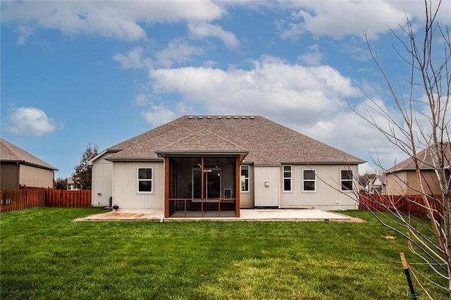 rear view of house with a yard, a patio area, a fenced backyard, and a shingled roof