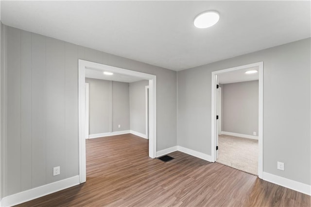 empty room with hardwood / wood-style flooring