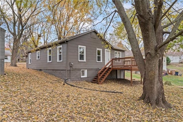 rear view of house featuring a deck