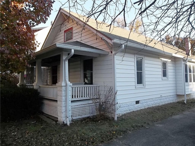 view of property exterior featuring covered porch