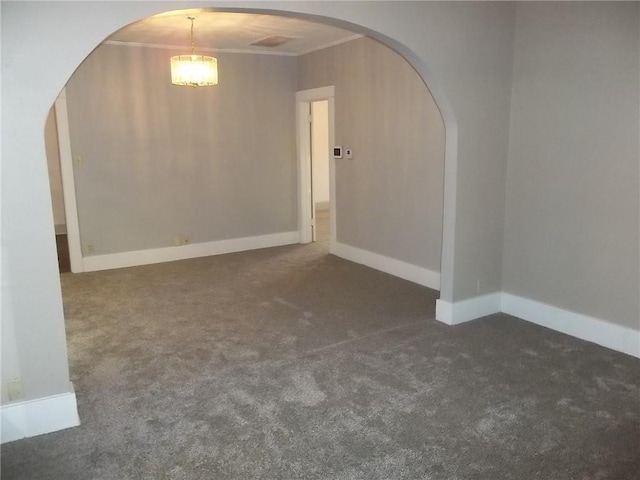 carpeted spare room featuring crown molding