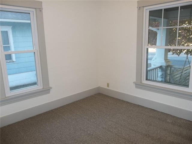 unfurnished room with carpet floors and plenty of natural light