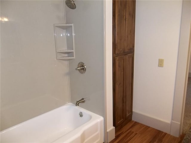 bathroom with shower / bathing tub combination and wood-type flooring