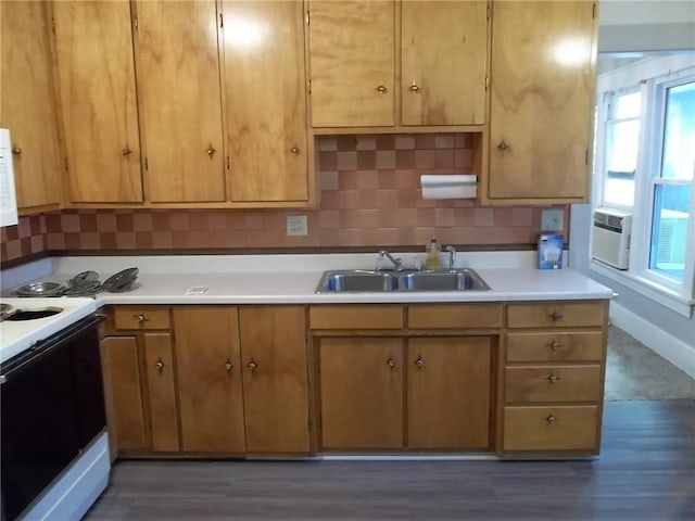 kitchen featuring dark hardwood / wood-style floors, white range with electric cooktop, tasteful backsplash, and sink