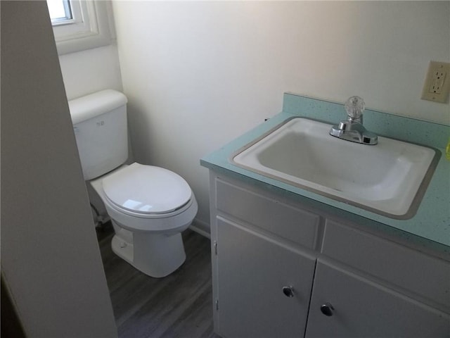 bathroom with vanity, hardwood / wood-style flooring, and toilet