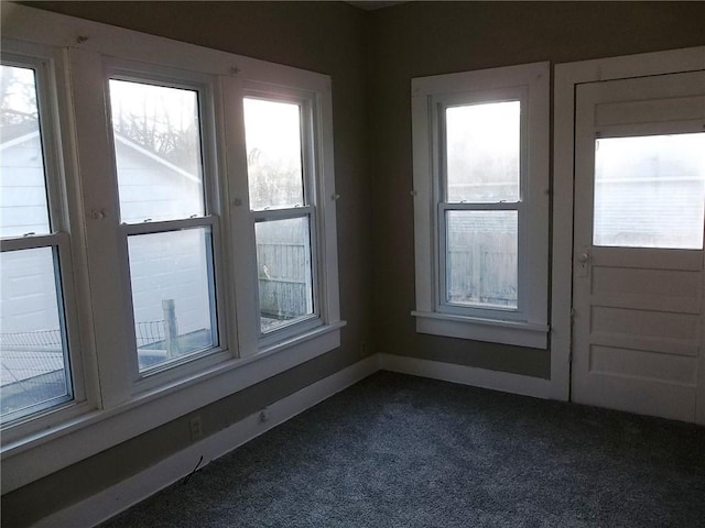 entryway with dark colored carpet