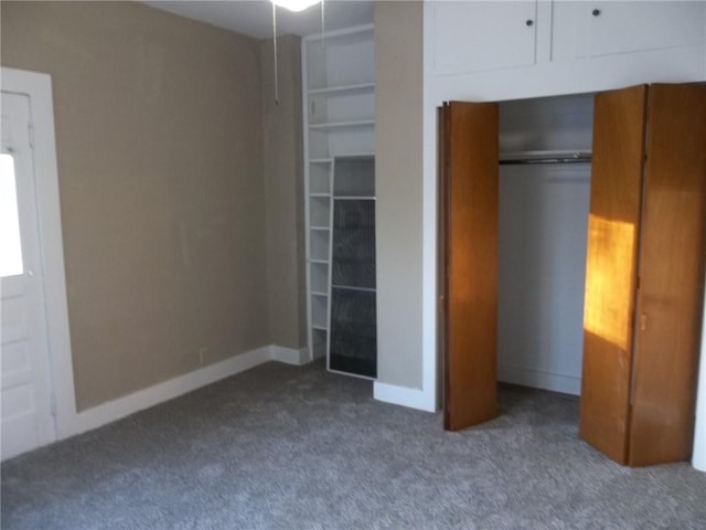 unfurnished bedroom with dark colored carpet