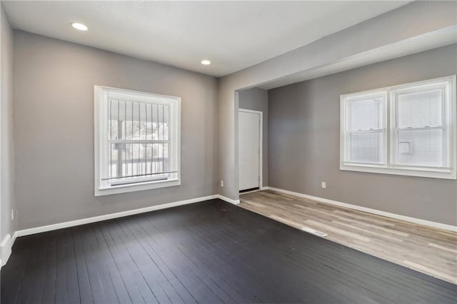 empty room with dark wood-type flooring