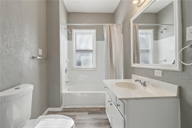 full bathroom featuring wood-type flooring, toilet, vanity, and shower / bath combo