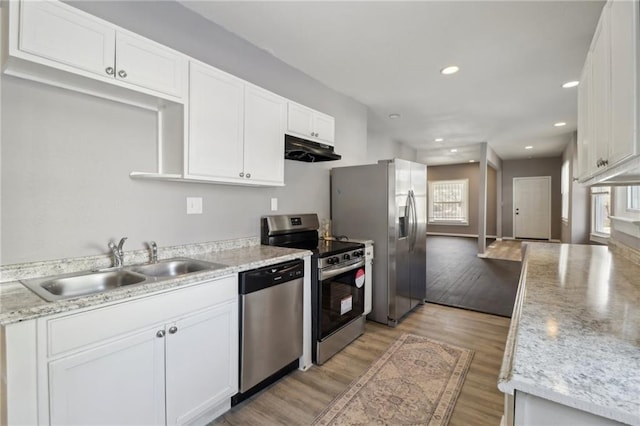 kitchen featuring white cabinets, sink, stainless steel appliances, and light hardwood / wood-style flooring