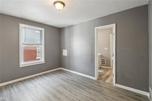 unfurnished room with wood-type flooring