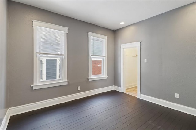 empty room featuring dark wood-type flooring