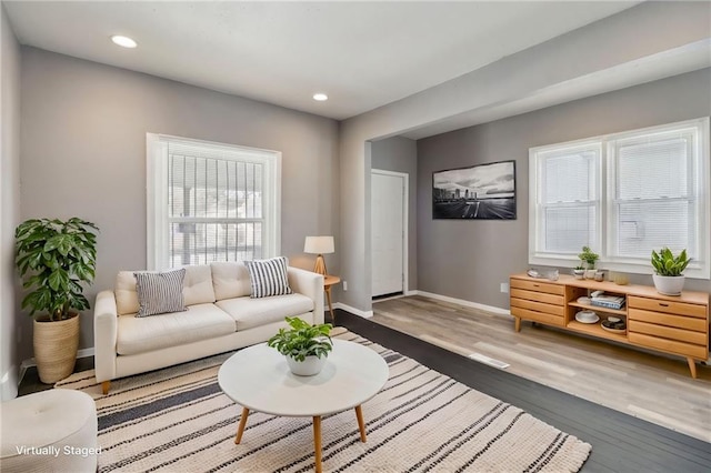 3231 Park Ave, Kansas City, MO 64109 - living room featuring recessed lighting, baseboards, and wood finished floors