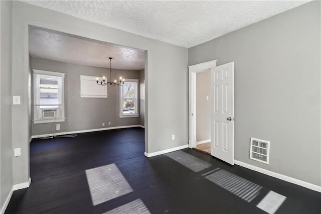 3231 Park Ave, Kansas City, MO 64109 - spare room with a chandelier, visible vents, and baseboards
