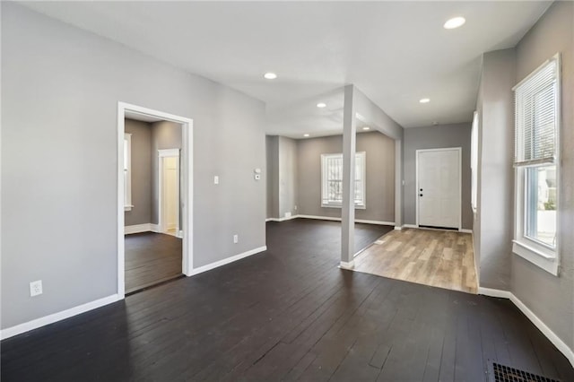 3231 Park Ave, Kansas City, MO 64109 - entrance foyer with visible vents, baseboards, plenty of natural light, and dark wood-style floors