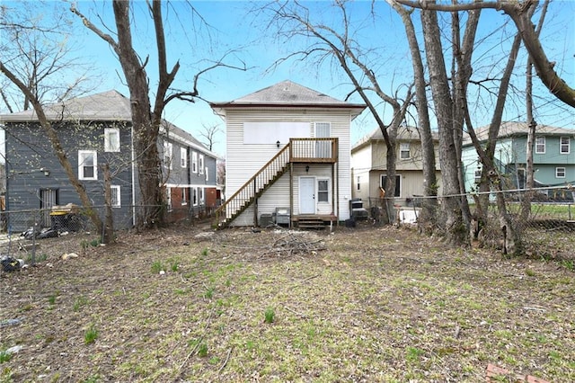 3231 Park Ave, Kansas City, MO 64109 - rear view of house with entry steps and a fenced backyard
