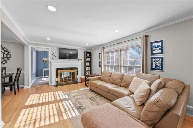 living room featuring light hardwood / wood-style flooring and ornamental molding