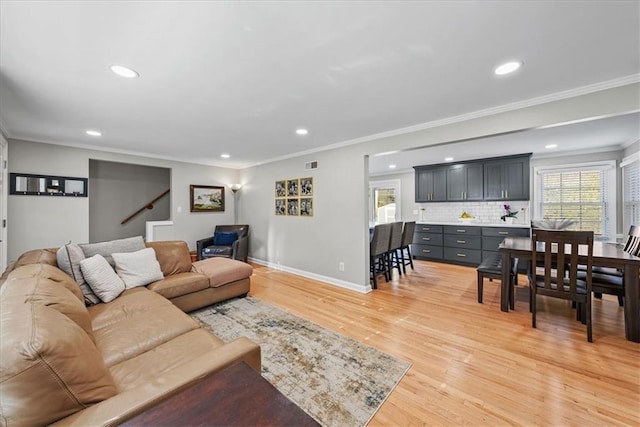 living room with hardwood / wood-style flooring and crown molding